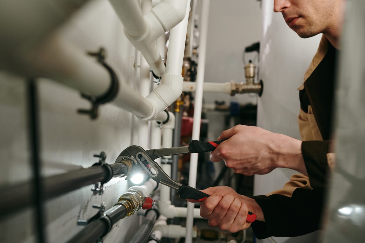 Plumbers maintaining commercial plumbing pipes in Colorado Springs