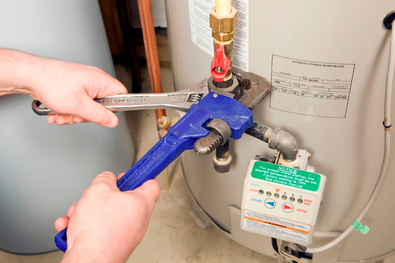 Plumber repairing a water heater valve in Colorado Springs